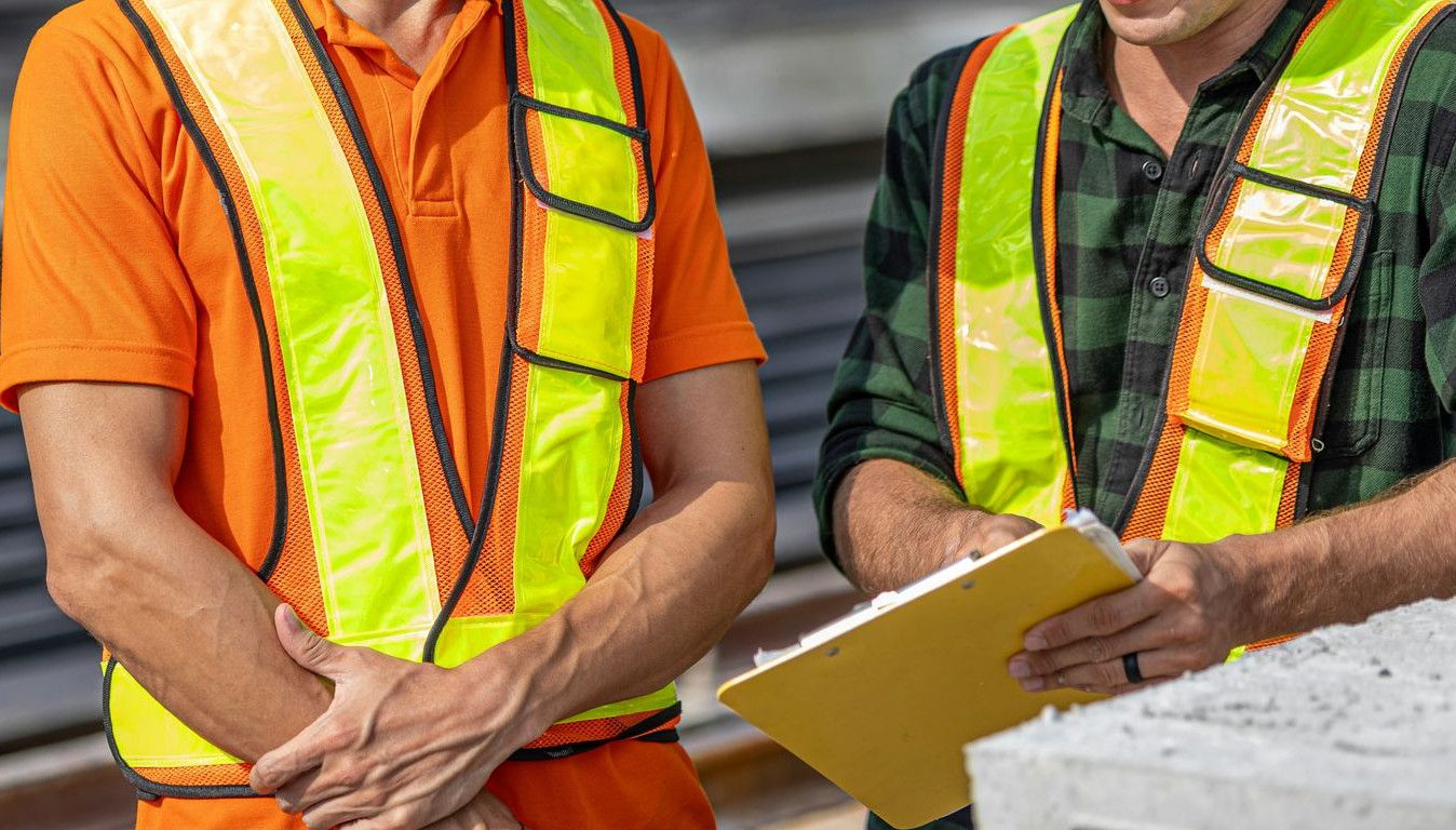 Construction workers review plans at a job site
